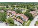 Aerial view of condo community with mature trees, lakeside views, carports, and well-maintained landscaping at 10356 Carrollwood Ln # 204, Tampa, FL 33618