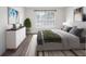Serene bedroom featuring a neutral color palette, a large window, and wood-look floors at 10356 Carrollwood Ln # 204, Tampa, FL 33618