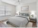 Comfortable bedroom with a large window offering natural light, and modern furnishings at 10356 Carrollwood Ln # 204, Tampa, FL 33618