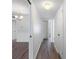 Bright hallway with white walls, wood-look floors, and convenient access to rooms at 10356 Carrollwood Ln # 204, Tampa, FL 33618