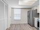 Spacious kitchen boasts laminate floors, stainless steel refrigerator and lots of light at 10356 Carrollwood Ln # 204, Tampa, FL 33618