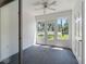 Enclosed lanai offers carpet floors, ceiling fan and doors to the outside at 10356 Carrollwood Ln # 204, Tampa, FL 33618