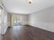 Spacious living room featuring wood floors, white trim and sliding glass doors to the lanai at 10356 Carrollwood Ln # 204, Tampa, FL 33618