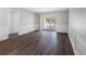 Inviting living room with beautiful wood floors, white trim and sliding glass doors to the lanai at 10356 Carrollwood Ln # 204, Tampa, FL 33618