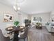 Bright living and dining area featuring modern decor and sliding glass doors to an outdoor space at 10356 Carrollwood Ln # 204, Tampa, FL 33618