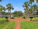 Community picnic area with grills and tables, surrounded by lush greenery and a scenic pond at 10356 Carrollwood Ln # 204, Tampa, FL 33618