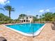 Large community pool with lounge chairs and manicured landscaping, perfect for relaxation and socializing at 10356 Carrollwood Ln # 204, Tampa, FL 33618