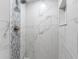 Modern bathroom shower featuring white marble-look tiles and mosaic accent at 10356 Carrollwood Ln # 204, Tampa, FL 33618