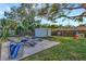 Backyard showing patio, lounge chairs, storage shed and play equipment at 10664 Starkey Rd, Seminole, FL 33777