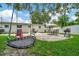A beautiful backyard with grass, patio, trampoline swing, table and game at 10664 Starkey Rd, Seminole, FL 33777