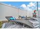 Backyard patio with lounge chairs, table and manicured landscape at 10664 Starkey Rd, Seminole, FL 33777