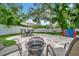 Outdoor patio with a table set, umbrella, fire pit and connect four game at 10664 Starkey Rd, Seminole, FL 33777