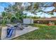 Backyard showing patio, lounge chairs, play equipment, and storage shed at 10664 Starkey Rd, Seminole, FL 33777