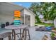 Backyard patio area with outdoor bar-height table, lounge chairs, and lawn at 10664 Starkey Rd, Seminole, FL 33777