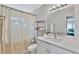 Bright bathroom featuring modern vanity, sleek fixtures, and neutral color palette with ample counter space and natural light at 10664 Starkey Rd, Seminole, FL 33777