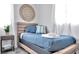 Cozy bedroom features a natural wood frame bed with stylish blue bedding and minimalist decor at 10664 Starkey Rd, Seminole, FL 33777
