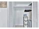View into an organized closet with white shelving and a three drawer black storage unit, offering ample space at 10664 Starkey Rd, Seminole, FL 33777