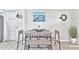 Dining area with wooden table, seating, and decorative coastal artwork at 10664 Starkey Rd, Seminole, FL 33777