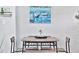 Dining area with wooden table, seating, and decorative coastal artwork at 10664 Starkey Rd, Seminole, FL 33777