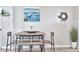 Dining area with wooden table, seating, and decorative coastal artwork at 10664 Starkey Rd, Seminole, FL 33777