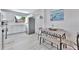 Open concept kitchen with dining area, stainless steel fridge, and white cabinets at 10664 Starkey Rd, Seminole, FL 33777
