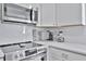 The kitchen features stainless steel appliances, modern backsplash and countertop appliances at 10664 Starkey Rd, Seminole, FL 33777