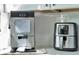The kitchen countertop has both a modern ice maker and air fryer at 10664 Starkey Rd, Seminole, FL 33777