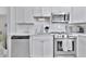 Modern kitchen with white cabinets, stainless steel appliances, and subway tile backsplash for a clean and stylish design at 10664 Starkey Rd, Seminole, FL 33777