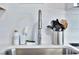 A sleek stainless steel sink with modern faucet and subway tile backsplash at 10664 Starkey Rd, Seminole, FL 33777