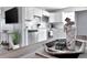 Modern kitchen featuring white cabinets, stainless steel appliances, and decorative seashell accents, perfect for a stylish home at 10664 Starkey Rd, Seminole, FL 33777