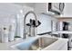Clean and modern kitchen with stainless steel sink and subway tile backsplash at 10664 Starkey Rd, Seminole, FL 33777