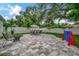 Paver patio features a seating area with umbrella and grill, fire pit and outdoor games at 10664 Starkey Rd, Seminole, FL 33777