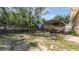 A serene backyard featuring a cozy, covered patio, ideal for outdoor dining and relaxation at 10912 N 61St St, Temple Terrace, FL 33617