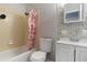 Bathroom with a shower-tub combo with yellow tiling, a matching toilet, and a vanity at 10912 N 61St St, Temple Terrace, FL 33617
