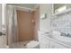 Cozy bathroom featuring a walk-in shower, white fixtures, and a tiled wall at 10912 N 61St St, Temple Terrace, FL 33617