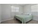 Comfortable bedroom featuring two windows, neutral walls, and a cozy bed at 10912 N 61St St, Temple Terrace, FL 33617