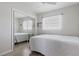 Bright bedroom featuring a mirrored closet door and two windows at 10912 N 61St St, Temple Terrace, FL 33617