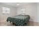 Bright bedroom featuring a ceiling fan, two windows, and a comfortable bed at 10912 N 61St St, Temple Terrace, FL 33617