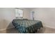 Comfortable bedroom with natural light and patterned bedding for a peaceful retreat at 10912 N 61St St, Temple Terrace, FL 33617