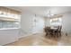 Dining room featuring hardwood-style floors and a wood table with matching chairs and a white door at 10912 N 61St St, Temple Terrace, FL 33617