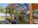 Charming backyard patio with a pergola, brick flooring, and lush greenery at 10912 N 61St St, Temple Terrace, FL 33617