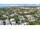 Aerial view of a residential neighborhood with lush trees, the ocean, and a city skyline in the distance at 1211 W Horatio St # A, Tampa, FL 33606