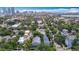 An aerial view of a residential area with lush trees, buildings, and the Tampa skyline in the background at 1211 W Horatio St # A, Tampa, FL 33606