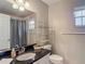Bathroom featuring vanity with black countertop, modern fixtures, and decorative shelving at 1211 W Horatio St # A, Tampa, FL 33606