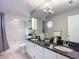 Bathroom featuring double sinks with granite countertops, bathtub, and tiled shower at 1211 W Horatio St # A, Tampa, FL 33606