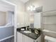 Bathroom vanity with a black countertop and ample storage space at 1211 W Horatio St # A, Tampa, FL 33606