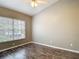 Bedroom with a large window, ceiling fan, and modern wood floors at 1211 W Horatio St # A, Tampa, FL 33606