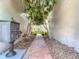 Charming courtyard walkway with brick path, lush greenery, and a 