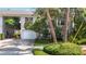 The front elevation of the home is enhanced by tropical landscaping, an attached garage, and a driveway at 1211 W Horatio St # A, Tampa, FL 33606