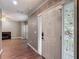 Bright foyer with wood floors leads to a spacious living area with fireplace, showcasing modern design at 1211 W Horatio St # A, Tampa, FL 33606